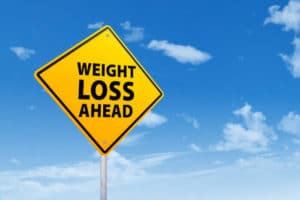 weight loss hacks yellow road sign