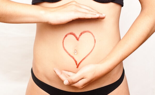 woman with hands framing belly