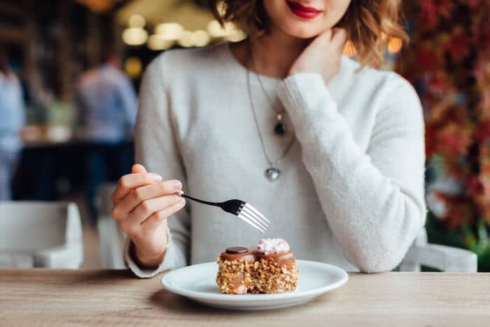 woman eating dessert at restaurant